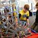 Huron High School Robotics team member David Earle, 15, of Ann Arbor shows 8-year-old Patrick Riley, of Farmington Hills, the robot his team built for a competition during Michigan Robotics Day at the Jack Roth Stadium Club at Michigan Stadium on Monday, April 15, 2013. Melanie Maxwell I AnnArbor.com